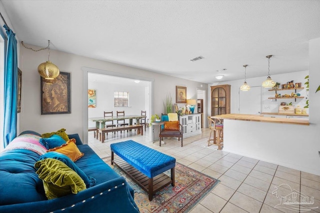 1404 Stanford Rd, Gulf Breeze, FL 32563 - living room with visible vents, a textured ceiling, and light tile patterned floors