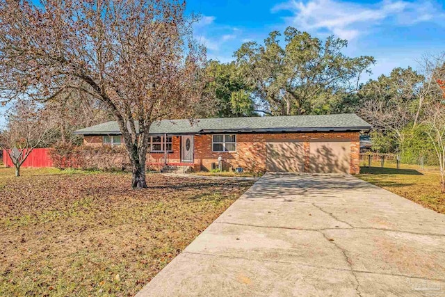 ranch-style house featuring a garage and a front lawn