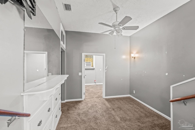 interior space with carpet, a textured ceiling, ceiling fan, and cooling unit