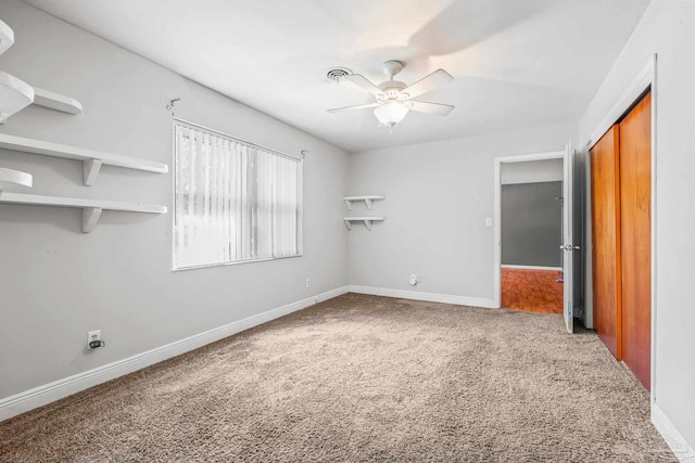 interior space with carpet flooring, ceiling fan, and a closet