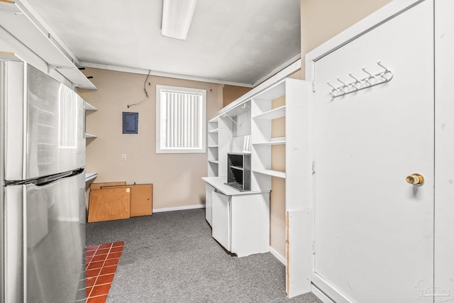 kitchen with stainless steel refrigerator, electric panel, and carpet floors