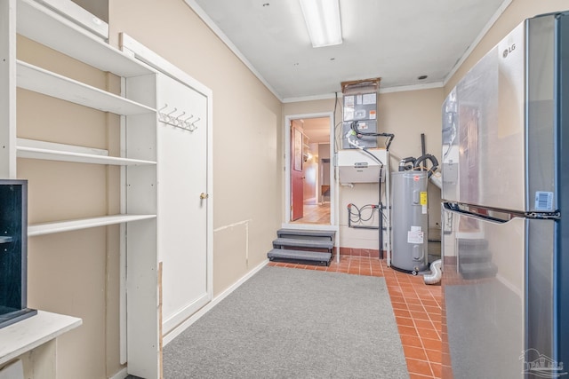 workout room with electric water heater and ornamental molding