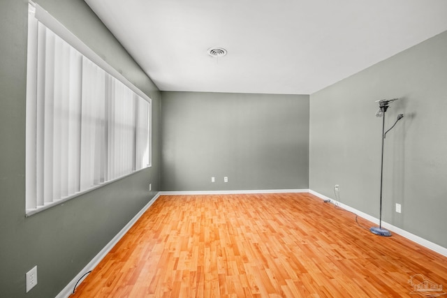 spare room featuring wood-type flooring