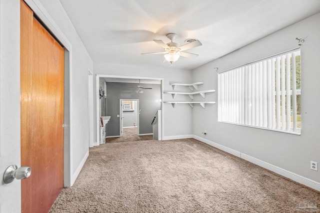 unfurnished bedroom featuring ceiling fan, a closet, and carpet