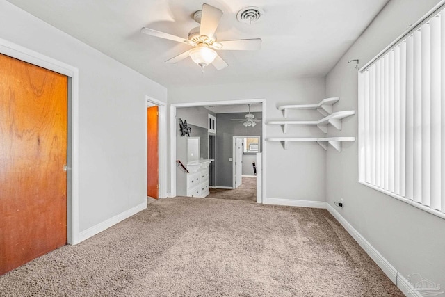 interior space featuring ceiling fan and carpet floors