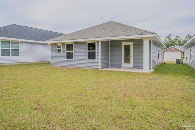 rear view of property featuring a patio area and a yard