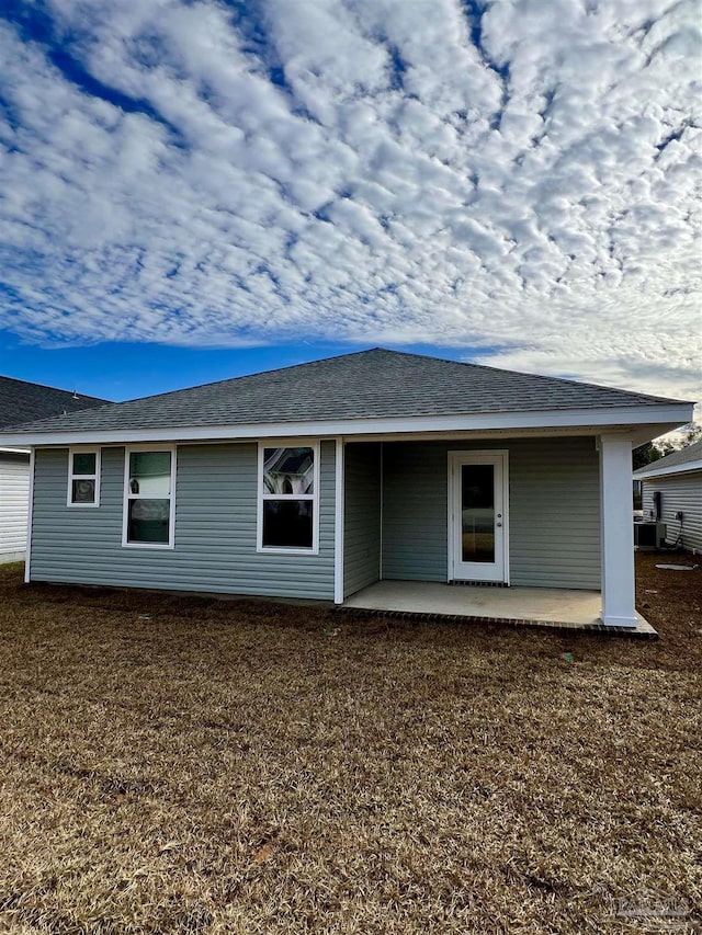 back of property with cooling unit and a patio area