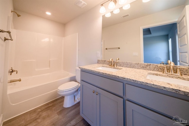 full bathroom featuring wood-type flooring, vanity, toilet, and shower / bathtub combination