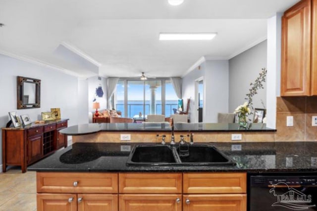 kitchen featuring dishwasher, sink, kitchen peninsula, dark stone counters, and decorative backsplash