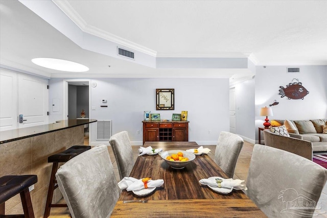 dining area featuring tile patterned floors and ornamental molding