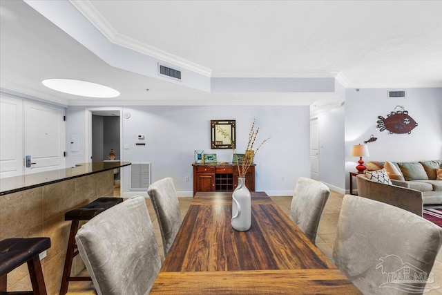 dining space with crown molding