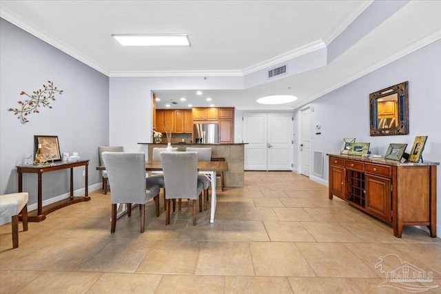 tiled dining room featuring crown molding