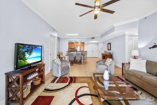 tiled living room with ceiling fan and crown molding