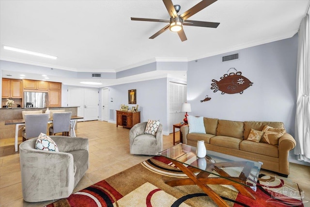 living room featuring ceiling fan, light tile patterned floors, and crown molding