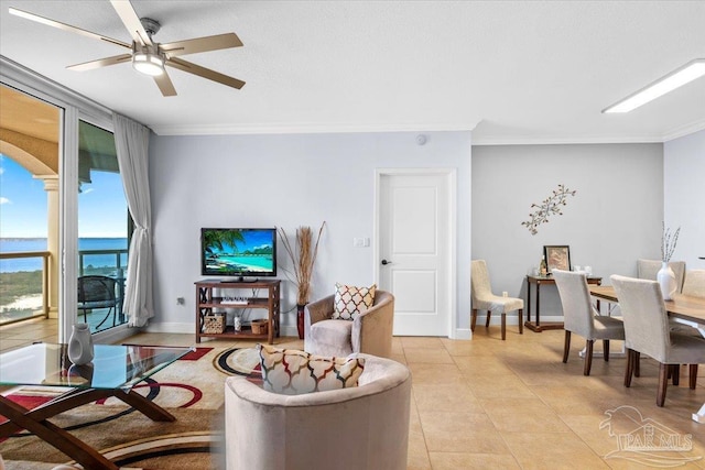 tiled living room with crown molding and ceiling fan