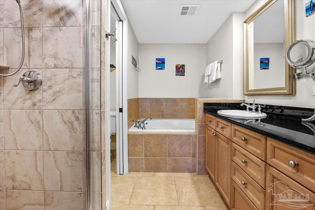 bathroom with tile patterned flooring, vanity, and independent shower and bath