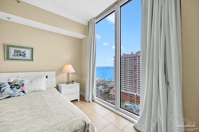 tiled bedroom with crown molding and a water view