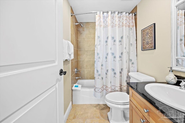 full bathroom featuring tile patterned floors, shower / tub combo with curtain, vanity, and toilet