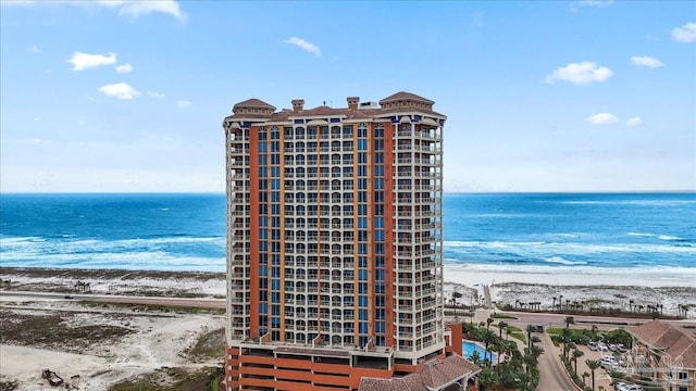 view of property with a water view and a view of the beach