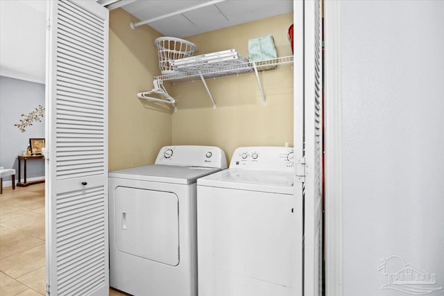 washroom featuring light tile patterned flooring and washing machine and clothes dryer