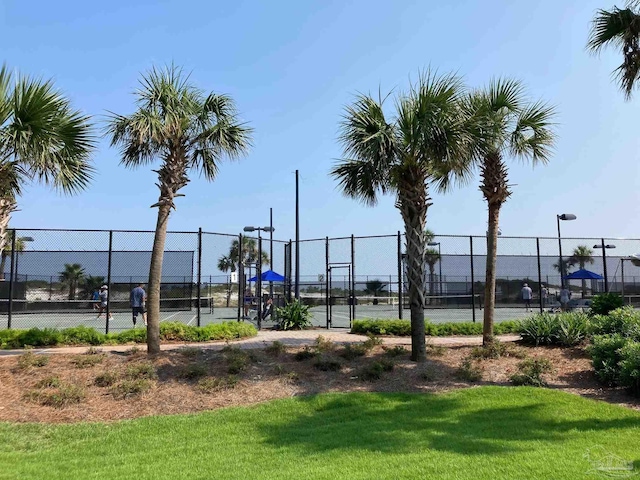 surrounding community featuring a lawn and tennis court