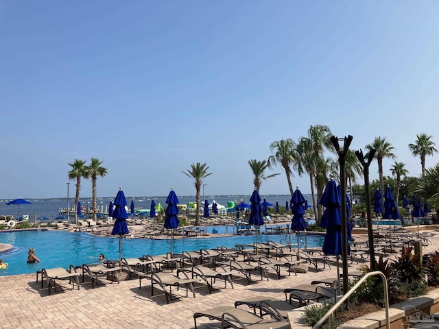 view of swimming pool featuring a water view