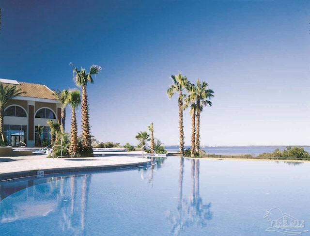 view of swimming pool featuring a water view