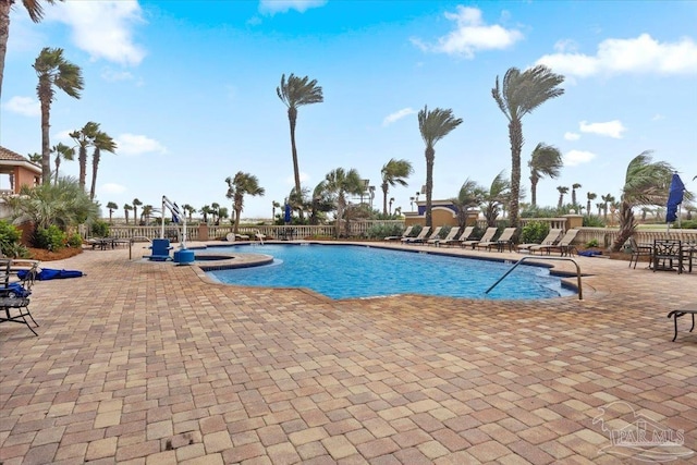 view of swimming pool with a patio area and a hot tub