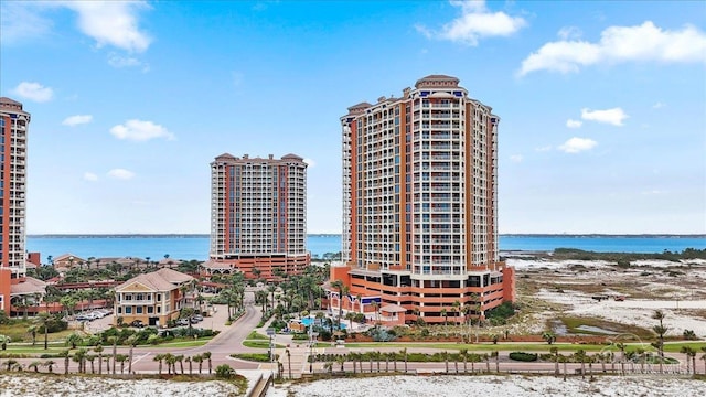 view of property featuring a beach view and a water view