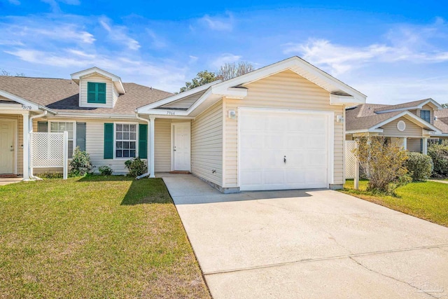 view of front of house with a front yard, concrete driveway, roof with shingles, and an attached garage