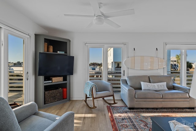 living room with ceiling fan and wood finished floors