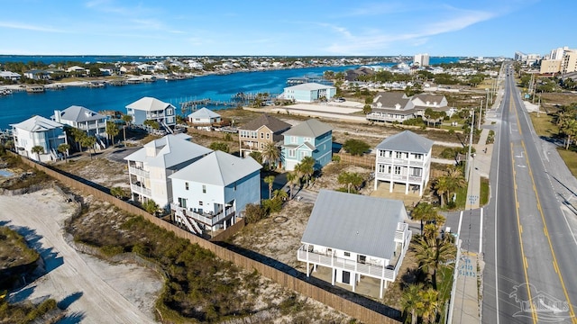 drone / aerial view with a water view and a residential view