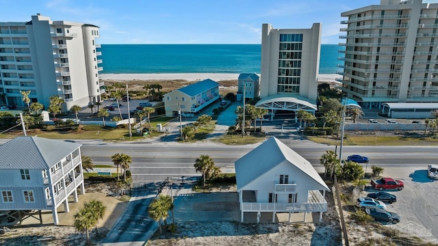 drone / aerial view with a water view and a view of the beach