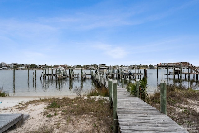 dock area with a water view and boat lift