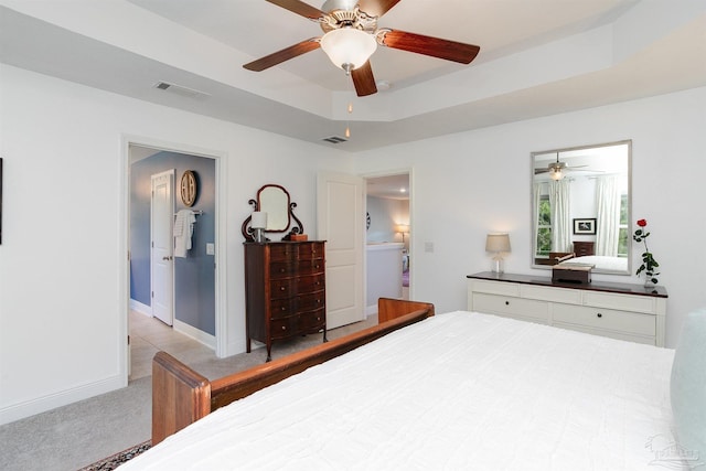 12806 Island Spirit Dr, Pensacola, FL 32506 - bedroom with visible vents, ceiling fan, light carpet, a raised ceiling, and baseboards
