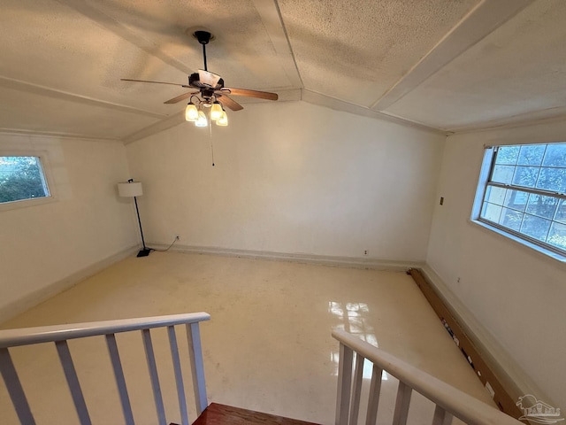 spare room with vaulted ceiling and a textured ceiling