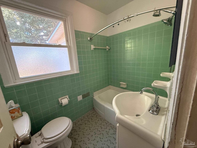 bathroom featuring toilet, tub / shower combination, tile walls, and vanity