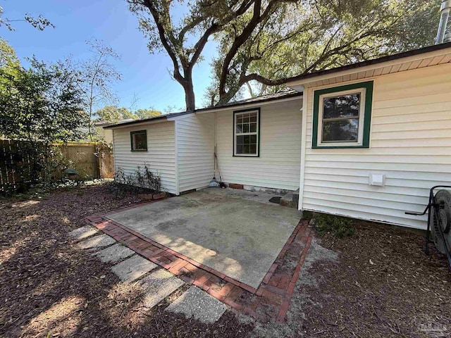 back of house with fence and a patio