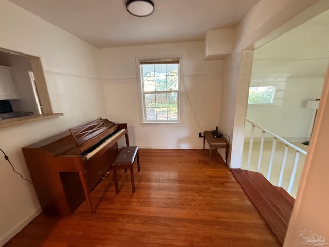 sitting room featuring wood finished floors and an upstairs landing