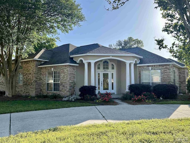 view of front of property with brick siding and a shingled roof