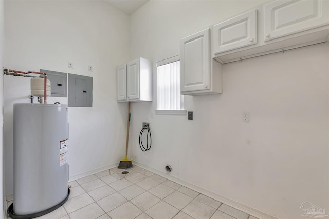 clothes washing area with electric water heater, electric panel, light tile patterned floors, cabinet space, and baseboards