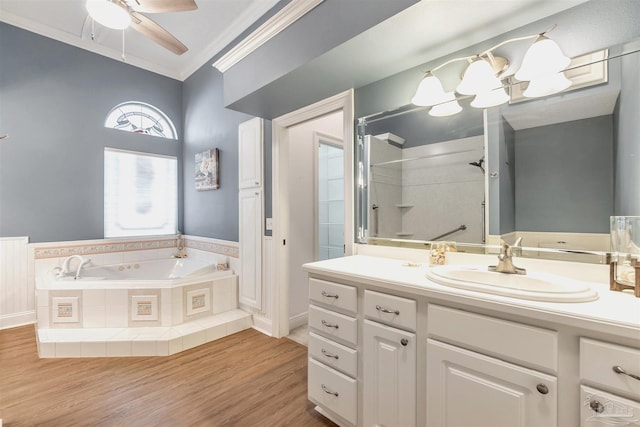 full bath with vanity, crown molding, a garden tub, a shower, and ceiling fan with notable chandelier