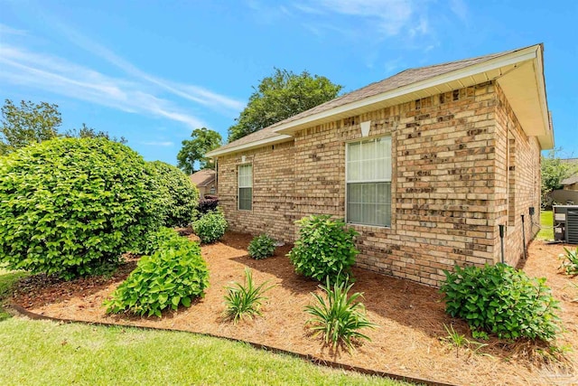 view of side of home with brick siding