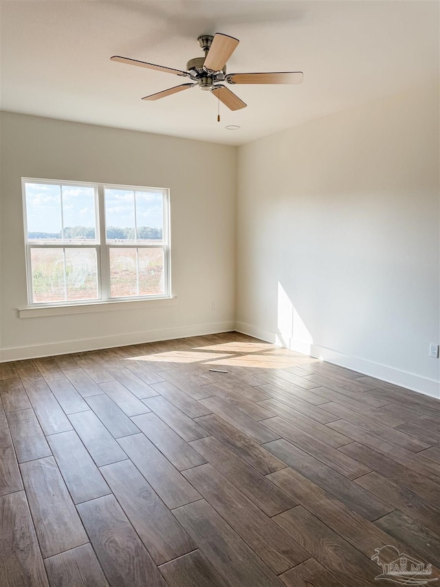 spare room featuring ceiling fan and dark hardwood / wood-style flooring