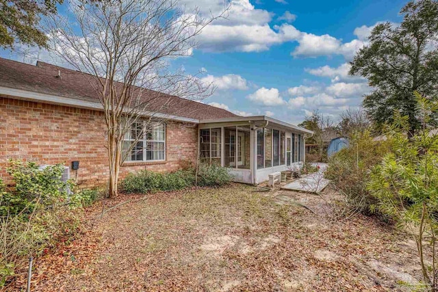 back of house featuring a sunroom