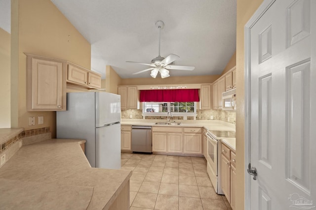 kitchen with white appliances, light tile patterned floors, decorative backsplash, ceiling fan, and sink