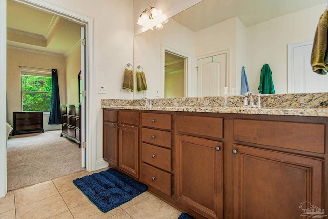 bathroom with dual vanity, tile patterned flooring, and a tray ceiling