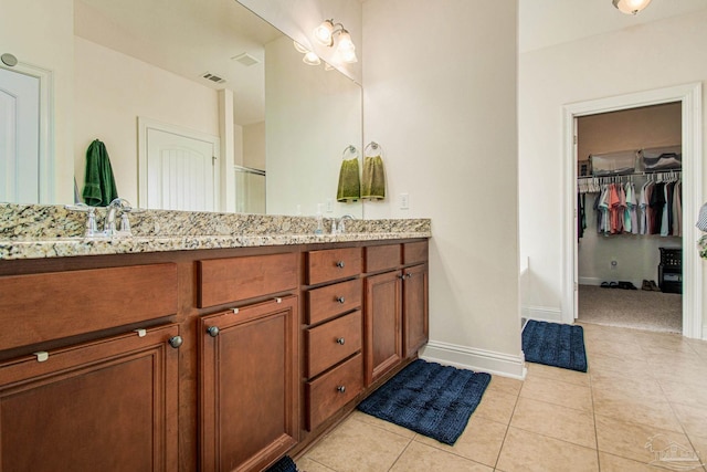 bathroom with tile patterned flooring and dual bowl vanity