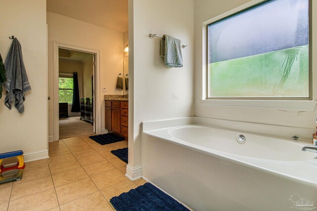 bathroom with vanity, tile patterned floors, and a bathtub