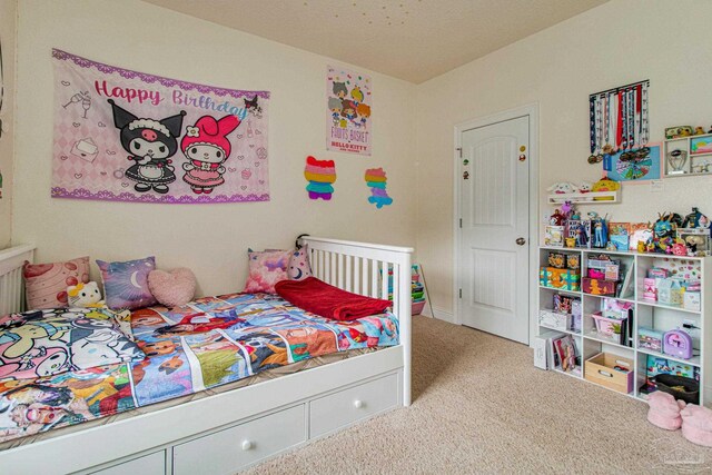 carpeted bedroom featuring a textured ceiling